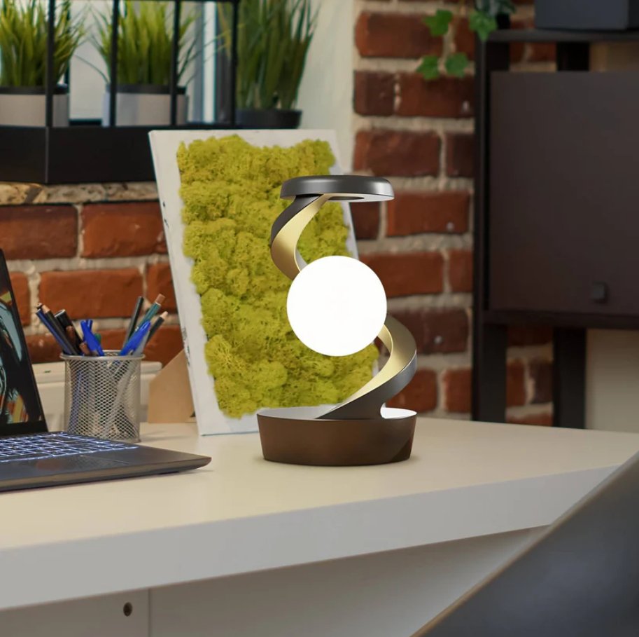 Modern rotating moon desk lamp with integrated wireless charging base, offering functional elegance for any desk or workspace.